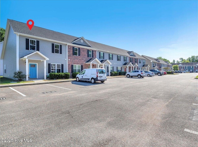 158 Lincoln Place Cir, Leland, NC 28451 - view of building exterior featuring a residential view and uncovered parking