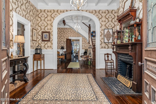 311 E Church St, Tarboro, NC 27886 - foyer featuring ornamental molding, wood-type flooring, an inviting chandelier, and wallpapered walls