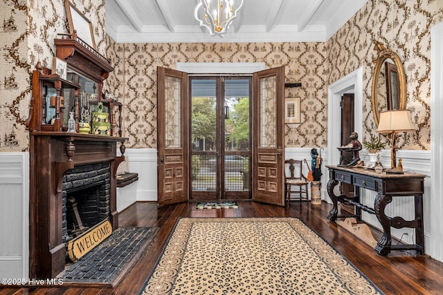 311 E Church St, Tarboro, NC 27886 - entryway featuring crown molding, a wainscoted wall, hardwood / wood-style floors, and wallpapered walls