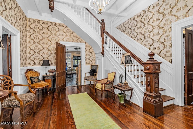 311 E Church St, Tarboro, NC 27886 - stairway featuring hardwood / wood-style floors, wallpapered walls, a notable chandelier, and ornamental molding
