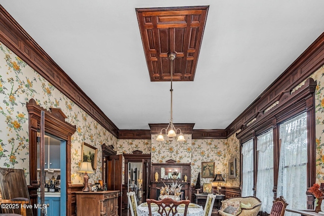 311 E Church St, Tarboro, NC 27886 - dining room with a notable chandelier, wallpapered walls, and crown molding