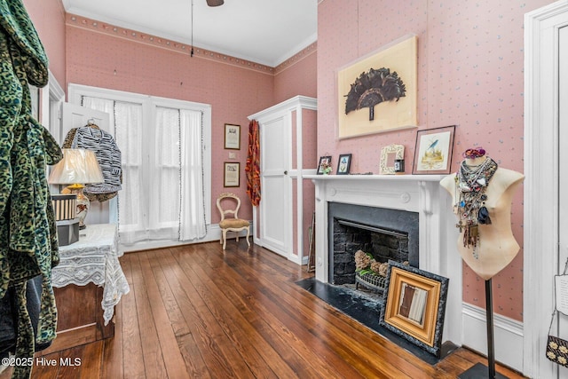 311 E Church St, Tarboro, NC 27886 - living area with a fireplace with flush hearth, hardwood / wood-style floors, wallpapered walls, and crown molding