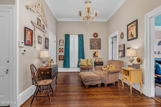 311 E Church St, Tarboro, NC 27886 - sitting room with ornamental molding, baseboards, a notable chandelier, and wood finished floors