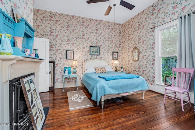 311 E Church St, Tarboro, NC 27886 - bedroom with crown molding, a fireplace, wood finished floors, and wallpapered walls