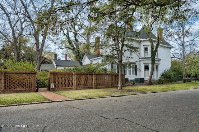 311 E Church St, Tarboro, NC 27886 - view of home's exterior with a gate, a chimney, and a fenced front yard