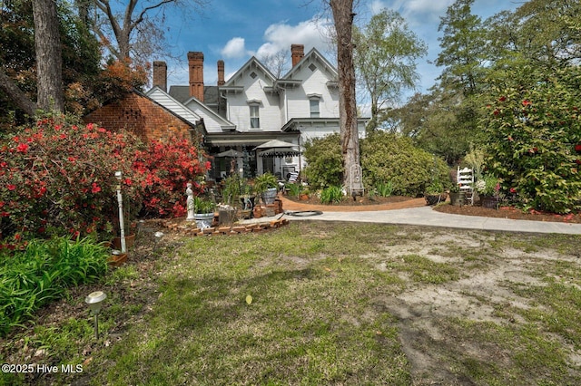 311 E Church St, Tarboro, NC 27886 - view of front of property with a front yard, a patio area, and a chimney
