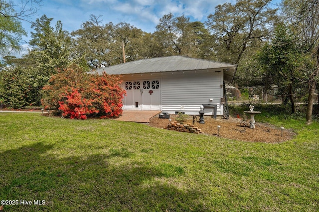 311 E Church St, Tarboro, NC 27886 - exterior space featuring a yard, metal roof, and an outbuilding
