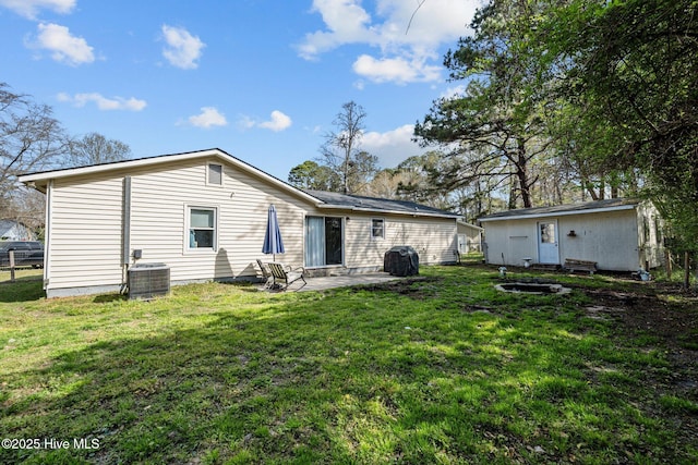 back of house featuring a lawn, central air condition unit, a patio, and fence