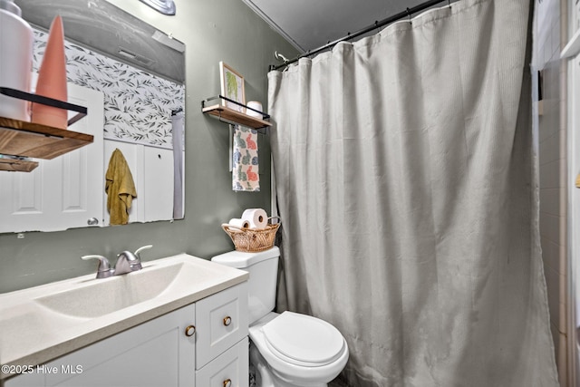 bathroom featuring curtained shower, toilet, and vanity