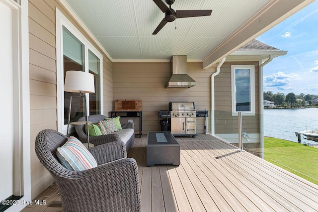 wooden terrace with a grill, exterior kitchen, ceiling fan, a water view, and outdoor lounge area