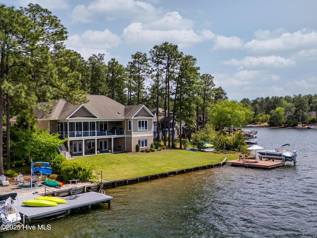 exterior space with a water view and a lawn