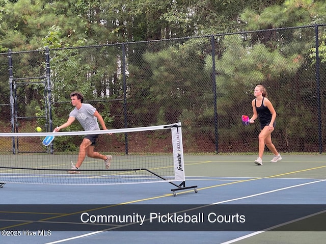 view of tennis court with fence