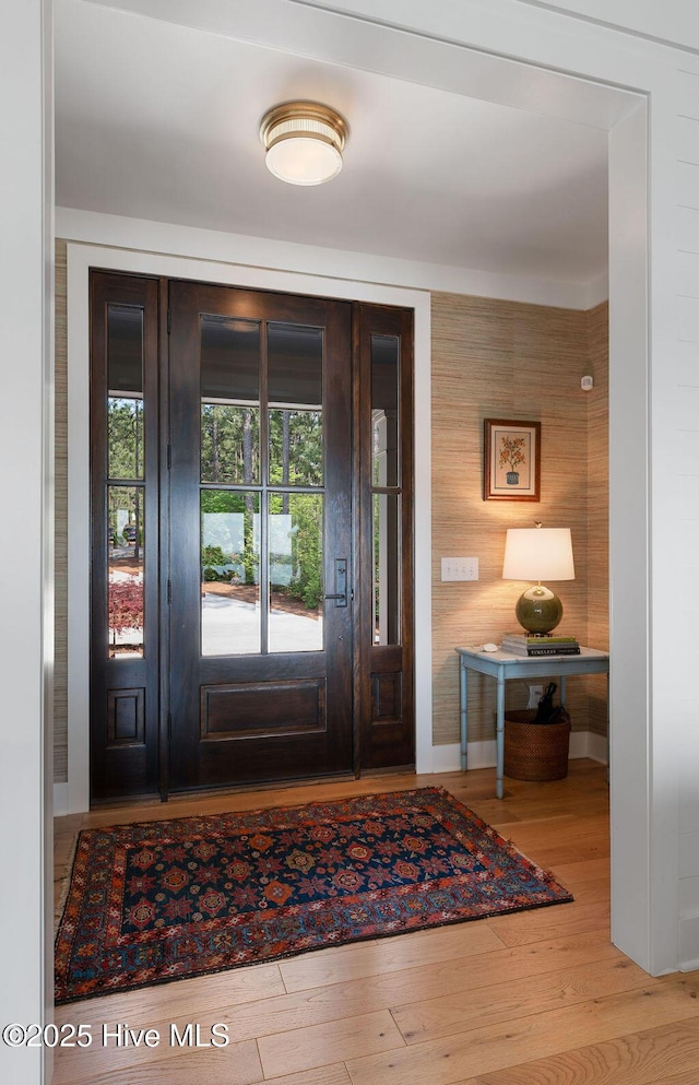 foyer with wood finished floors and baseboards