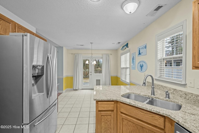 301 Derby Park Ave, New Bern, NC 28562 - kitchen with a textured ceiling, visible vents, a sink, stainless steel fridge with ice dispenser, and light tile patterned floors