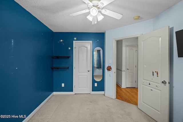 301 Derby Park Ave, New Bern, NC 28562 - unfurnished bedroom with baseboards, carpet, a textured ceiling, and a ceiling fan