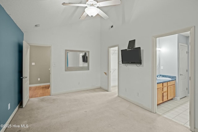 301 Derby Park Ave, New Bern, NC 28562 - unfurnished living room with visible vents, light carpet, ceiling fan, high vaulted ceiling, and a sink