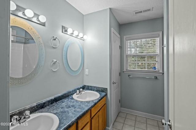 301 Derby Park Ave, New Bern, NC 28562 - bathroom featuring a textured ceiling, visible vents, a sink, and tile patterned flooring