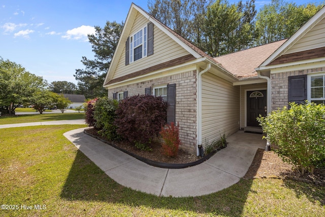 301 Derby Park Ave, New Bern, NC 28562 - view of side of home featuring a yard, brick siding, and a shingled roof