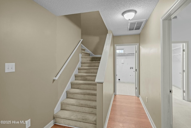 301 Derby Park Ave, New Bern, NC 28562 - stairway with a textured ceiling, visible vents, baseboards, and wood finished floors