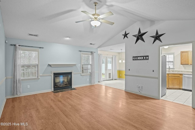 301 Derby Park Ave, New Bern, NC 28562 - unfurnished living room featuring ceiling fan, visible vents, a fireplace with flush hearth, vaulted ceiling, and a sink