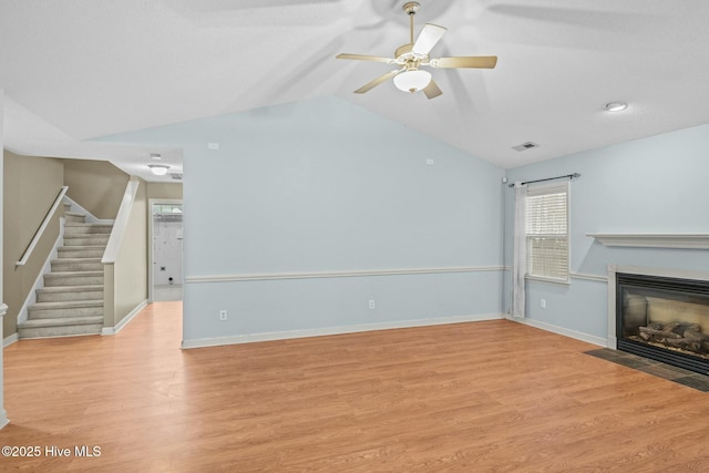 301 Derby Park Ave, New Bern, NC 28562 - unfurnished living room with visible vents, a fireplace with flush hearth, light wood-type flooring, lofted ceiling, and stairs