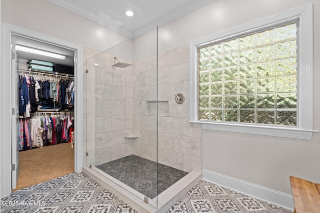 full bathroom with a healthy amount of sunlight, crown molding, walk in shower, tile patterned floors, and baseboards