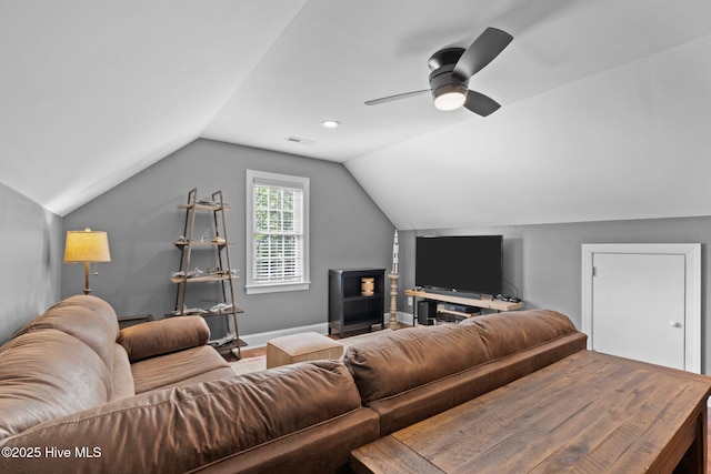 living room featuring a ceiling fan, baseboards, visible vents, and lofted ceiling