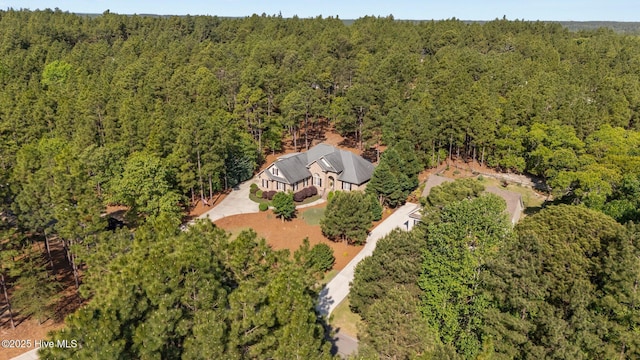 birds eye view of property featuring a wooded view