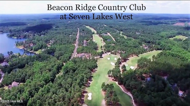 bird's eye view featuring a water view, a wooded view, and golf course view