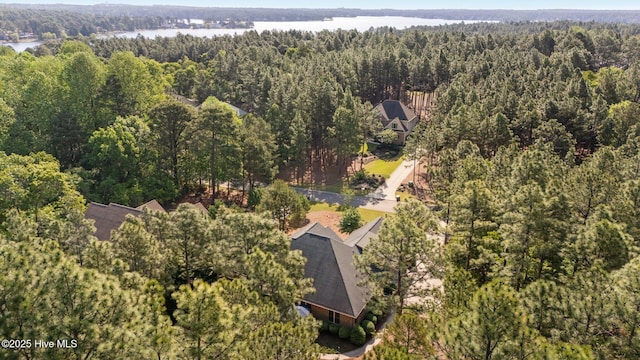 aerial view featuring a view of trees and a water view