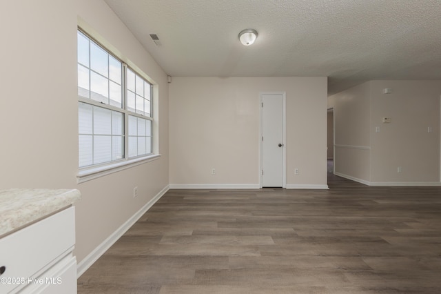 3002 E Windgate Ct, Jacksonville, NC 28546 - empty room featuring visible vents, a textured ceiling, baseboards, and wood finished floors