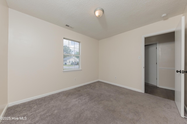 3002 E Windgate Ct, Jacksonville, NC 28546 - unfurnished bedroom featuring baseboards, carpet flooring, a textured ceiling, and visible vents