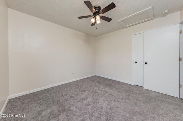 3002 E Windgate Ct, Jacksonville, NC 28546 - unfurnished bedroom featuring attic access, baseboards, carpet floors, and a textured ceiling