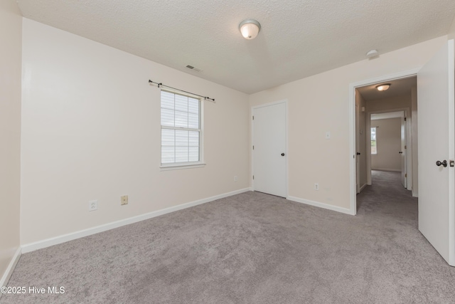 3002 E Windgate Ct, Jacksonville, NC 28546 - unfurnished room with baseboards, a textured ceiling, visible vents, and carpet