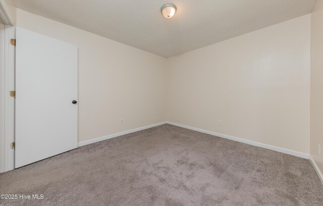 3002 E Windgate Ct, Jacksonville, NC 28546 - spare room with baseboards, carpet floors, and a textured ceiling