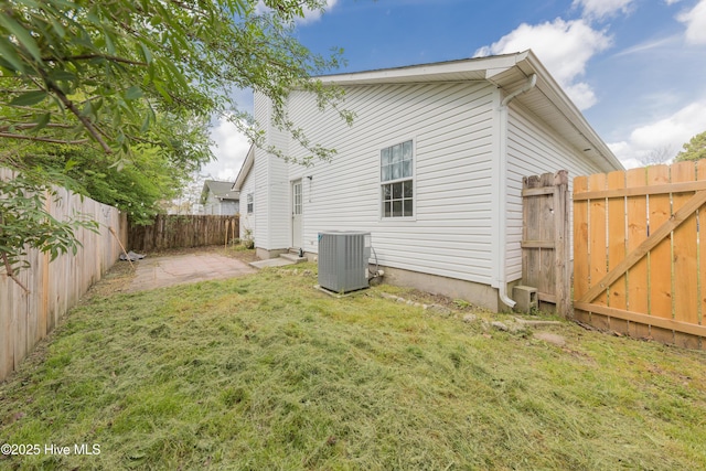 3002 E Windgate Ct, Jacksonville, NC 28546 - back of property with central air condition unit, a lawn, a fenced backyard, and a patio
