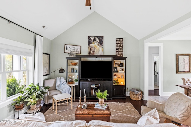 5994 Gray Squirrel Path, Southport, NC 28461 - living room featuring wood finished floors, baseboards, high vaulted ceiling, and a ceiling fan