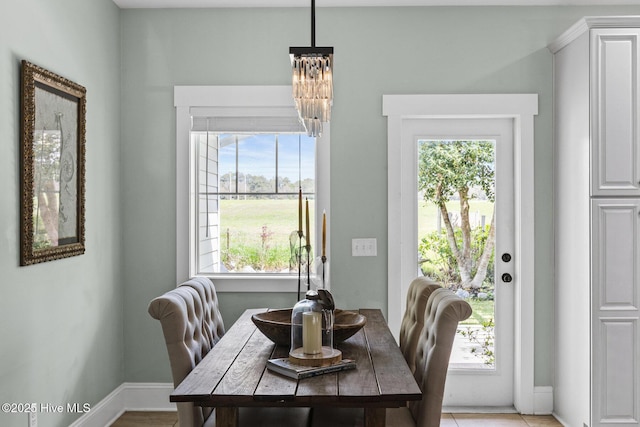 5994 Gray Squirrel Path, Southport, NC 28461 - dining area featuring a chandelier, healthy amount of natural light, and baseboards