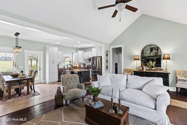 5994 Gray Squirrel Path, Southport, NC 28461 - living area featuring a ceiling fan, light wood-style flooring, plenty of natural light, recessed lighting, and high vaulted ceiling