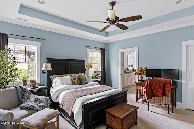 5994 Gray Squirrel Path, Southport, NC 28461 - bedroom with light colored carpet, a raised ceiling, crown molding, baseboards, and connected bathroom