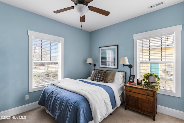 5994 Gray Squirrel Path, Southport, NC 28461 - bedroom featuring light colored carpet, multiple windows, baseboards, and ceiling fan
