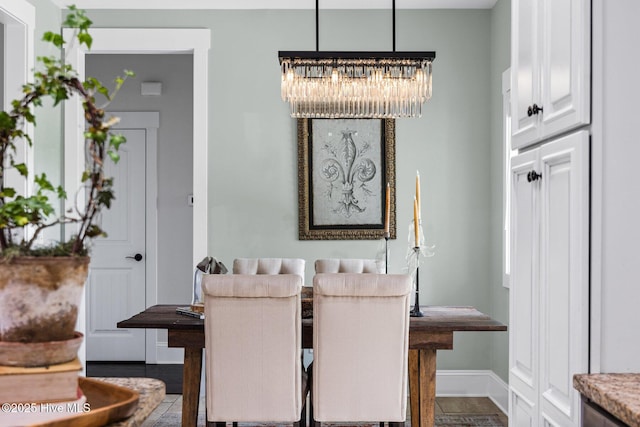 5994 Gray Squirrel Path, Southport, NC 28461 - dining space with a chandelier and baseboards
