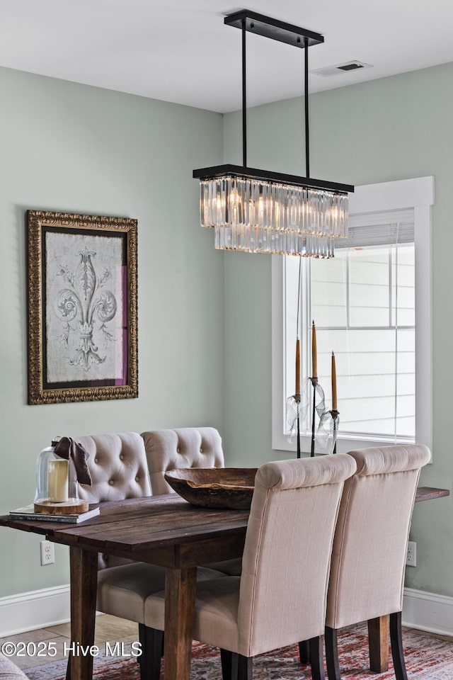 5994 Gray Squirrel Path, Southport, NC 28461 - dining space featuring a chandelier and baseboards