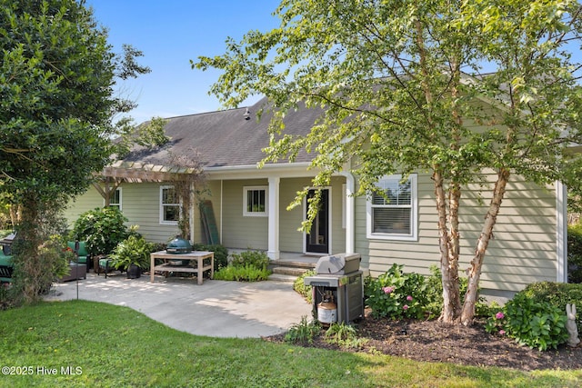 5994 Gray Squirrel Path, Southport, NC 28461 - back of house featuring a patio area and a shingled roof