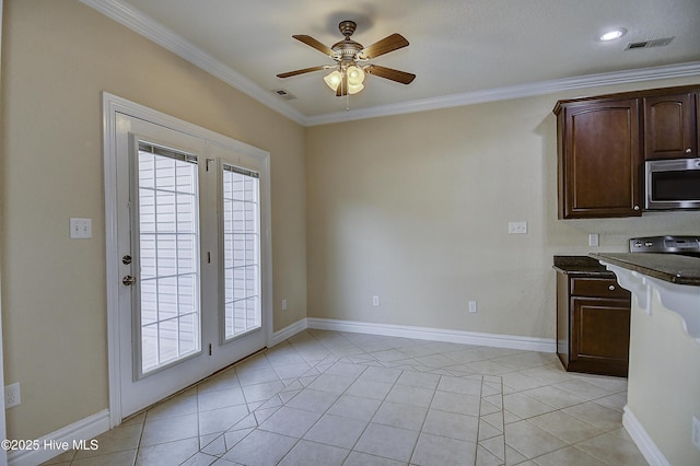 103 Whistling Duck Ct, Moyock, NC 27958 - kitchen featuring stainless steel microwave, crown molding, ceiling fan, dark brown cabinetry, and baseboards