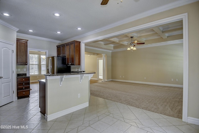 103 Whistling Duck Ct, Moyock, NC 27958 - kitchen featuring a ceiling fan, light colored carpet, freestanding refrigerator, dark countertops, and crown molding