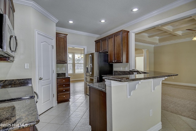 103 Whistling Duck Ct, Moyock, NC 27958 - kitchen with a kitchen breakfast bar, light tile patterned flooring, crown molding, stainless steel appliances, and recessed lighting