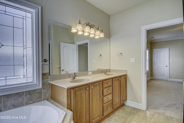 103 Whistling Duck Ct, Moyock, NC 27958 - bathroom with double vanity, tile patterned floors, a bathtub, baseboards, and crown molding