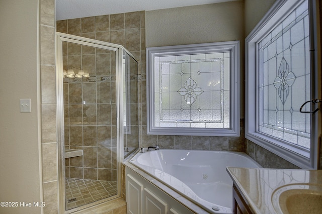 103 Whistling Duck Ct, Moyock, NC 27958 - bathroom featuring a shower stall, a tub with jets, and vanity
