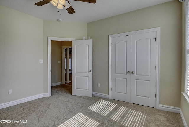 103 Whistling Duck Ct, Moyock, NC 27958 - unfurnished bedroom with carpet flooring, a closet, baseboards, and ceiling fan